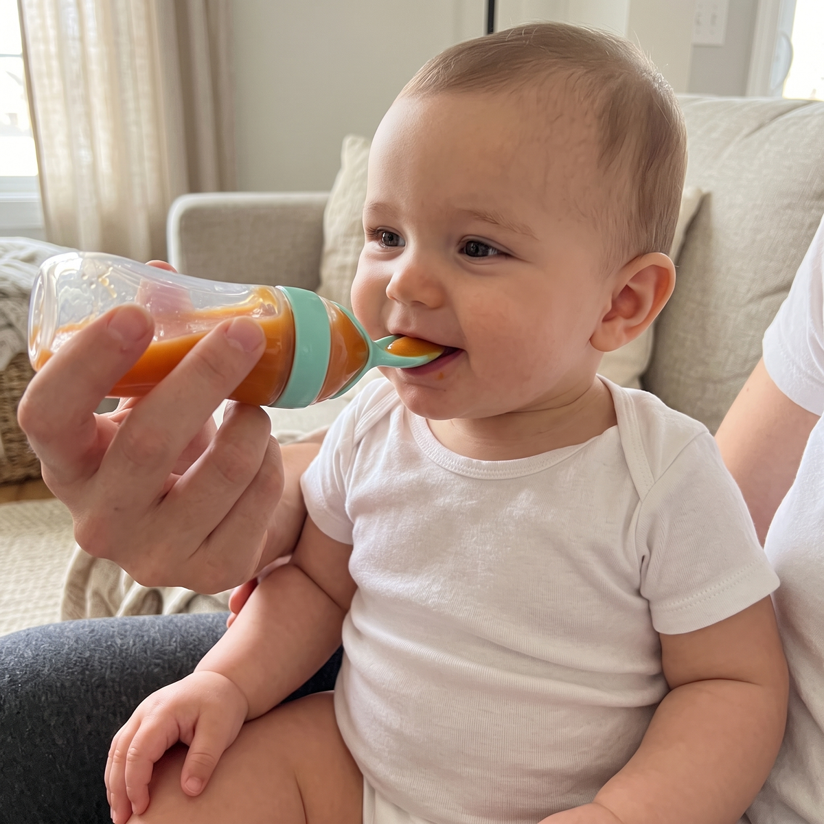 Baby eating mess-free from the squeeze spoon feeder